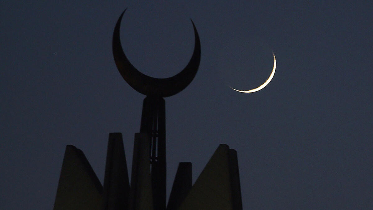 The new crescent moon of Ramadan rises over the Faisal Mosque in Islamabad, Pakistan.
 Farooq Naeem/AFP