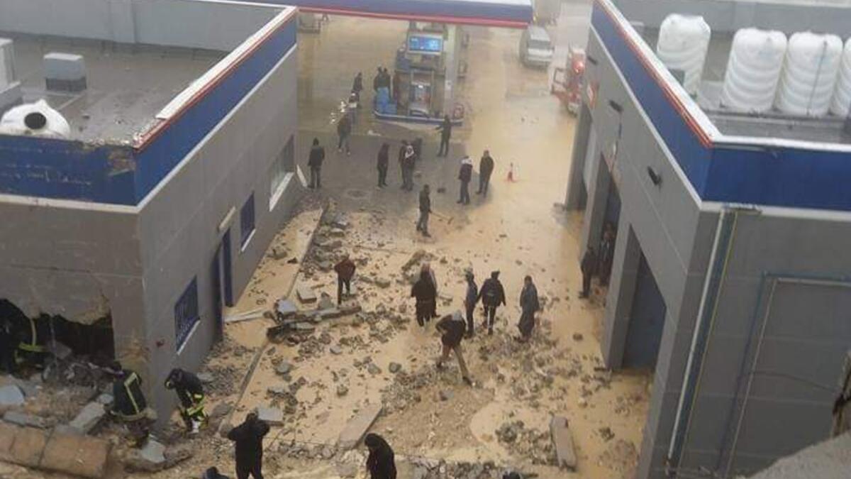 The collapse of a large building wall above the workers ' rooms and they are now under the rubble at the Manaseer station in Jerusalem Street in Jordan. (Twitter)