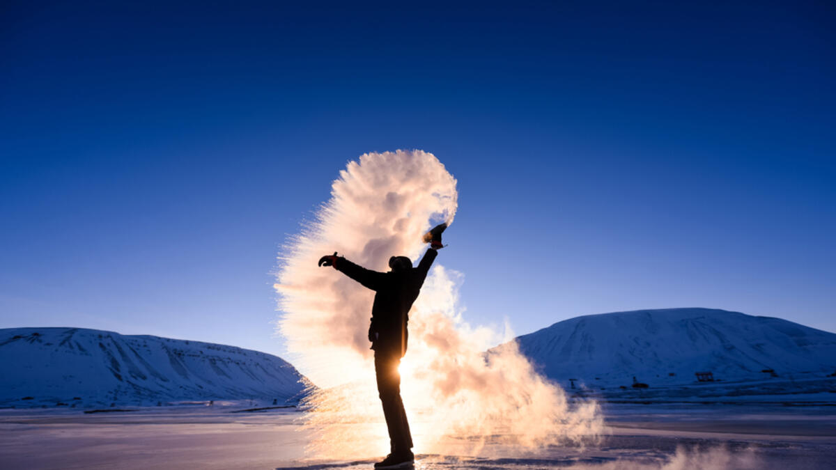 Boiling water frost in polar arctic sky in Norway Svalbard in Longyearbyen man mountains. (Shutterstock/ File Photo)