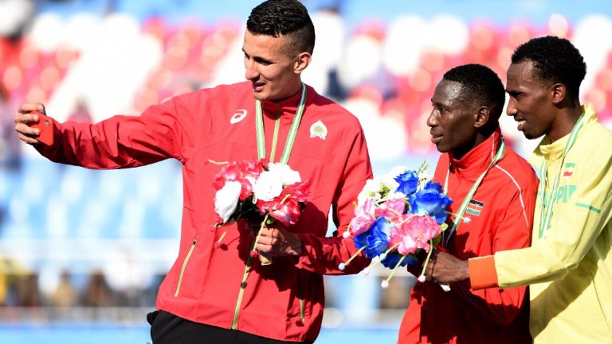 Gold medalist Kenya's Conseslus Kipruto (C), silver medalist Morocco's Bakkali Soufiane (L) and bronze medalist Ethiopia's Getnet Wale Bayabl pose for a selfie after the Men's 3000 meter Steeplechase final at the African Senior Athletics Championship in Asaba, Delta State, Midwestern Nigeria, on Aug 3, 2018.
PIUS UTOMI EKPEI / AFP