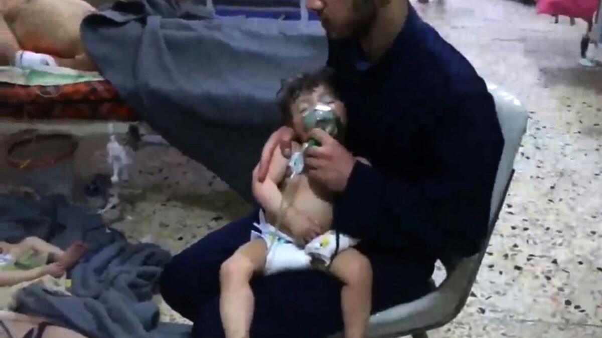 An image grab from a video released by the Syrian Civil Defense shows hospital volunteers giving aid to children after an alleged chemical attack in Douma on Saturday (AFP)