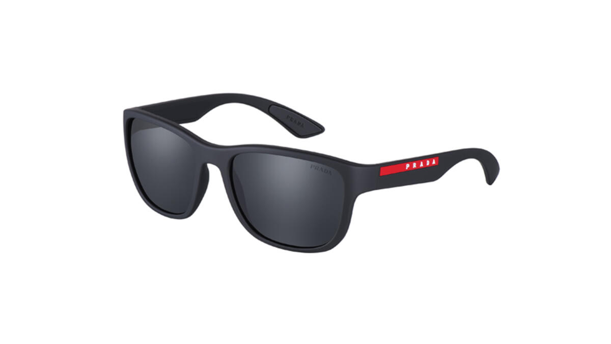 Linear aesthetics and an ‘active’ attitude are the key themes of the second sunglasses of the new Prada Linea Rossa Flask collection. The squared wraparound front is combined with thick temples, highlighted by the iconic red stripe logo.The rubber coating comes in an array of colors: Black, Grey, Dark Chocolate,White, and Amaranth.