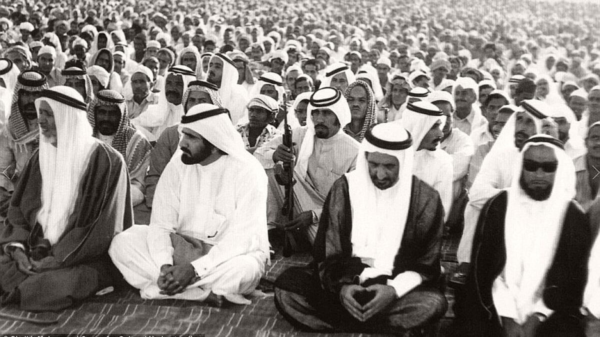 Men reciting prayers for the Muslim festival of Eid in Dubai, ca. 1960s