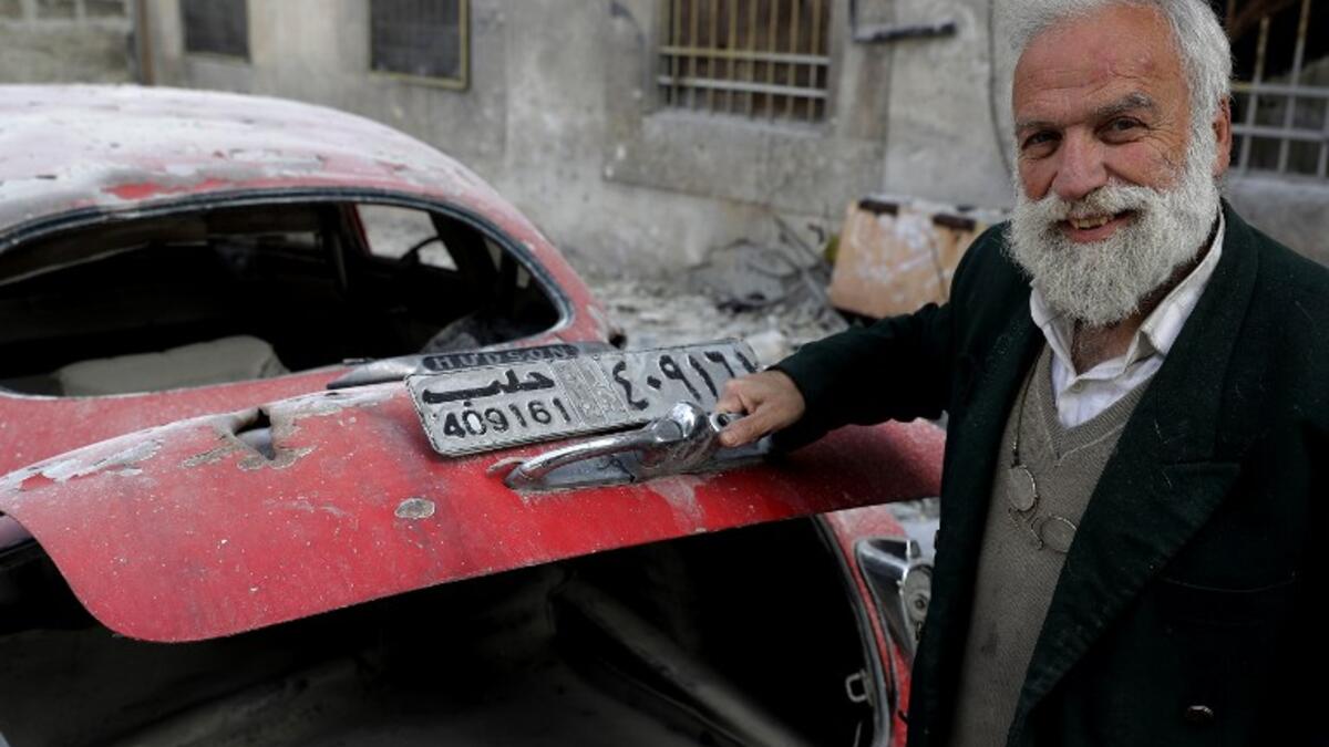 70-year-old Mohammed Anis opens the trunk of his 1949 Hudson Commodor outside his home in Aleppo. Most of his cars have either been damaged by shelling in the war or stolen by fighters. He left Aleppo just two months before the eastern part of the city fell to government forces, but later returned, vowing to restore his “wounded” cars.