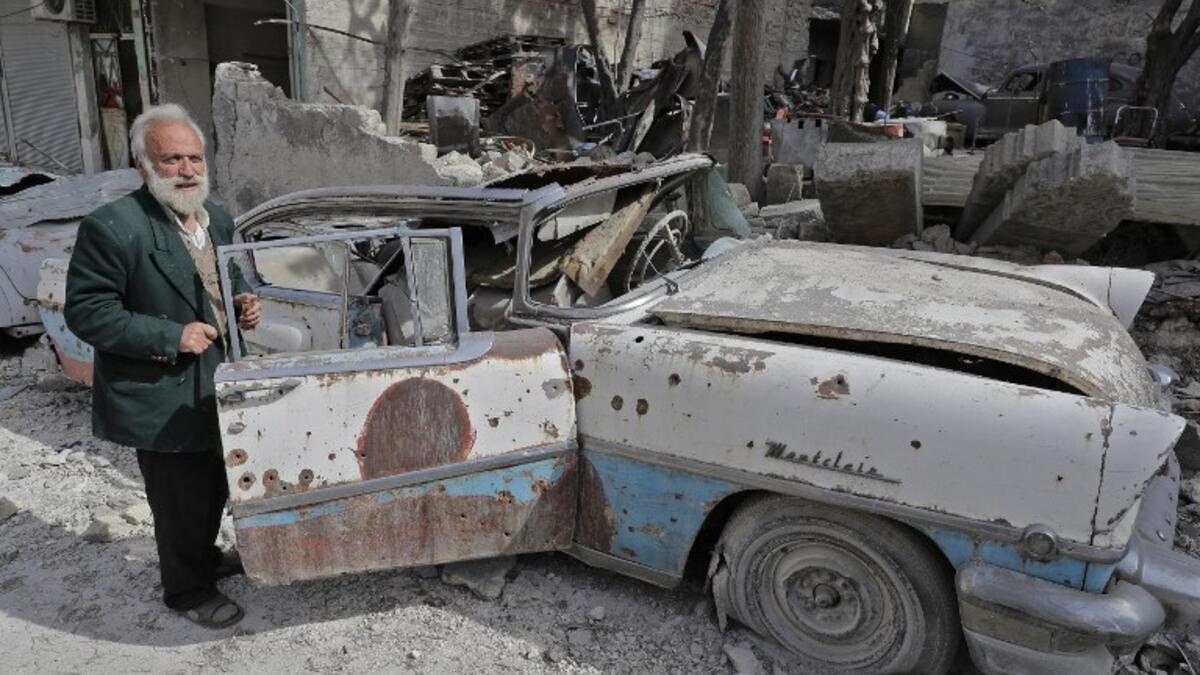 Mohammed inspects his 1957 Mercury Montclair outside his home in Aleppo. When asked “how can you live here?” he replied simply, “this is my home.”