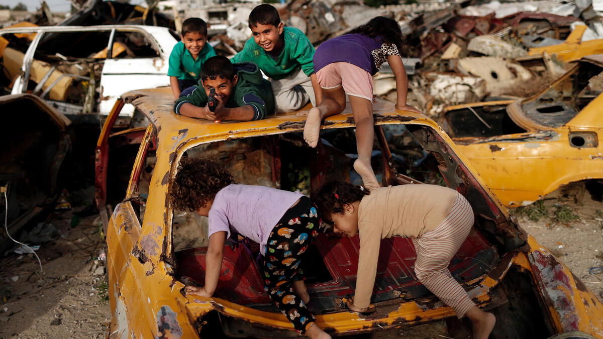 Palestinian children play amidst wrecked cars in an impoverished area of the southern Gazan city of Khan Yunis. Since the blockade of the Gaza strip following Hamas’ takeover, the economy has declined, the import of necessary materials has been difficult and the strip has come under repeated attack by Israeli forces.