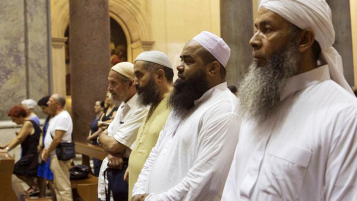Muslims take part in a mass at the Basilica of the Holy Cross in Jerusalem on July 31, 2016 in Rome, Italy. The worshippers had also gathered to mourn the death of murdered French Priest Jacques Hamel.