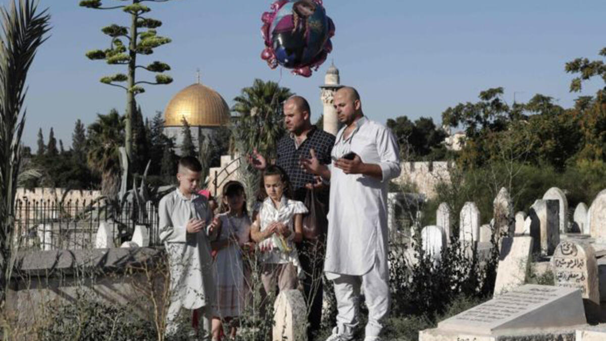 A Palestinian Family at a cemetery in Jerusalem’s old city during Eid. For many Palestinians, visiting the holy city and family members during Ramadan remains difficult. Although Israel issues special Ramadan permits for Palestinians to cross the 1967 border, access remains restricted and after an attack on June 17th, Israel revoked the permits.