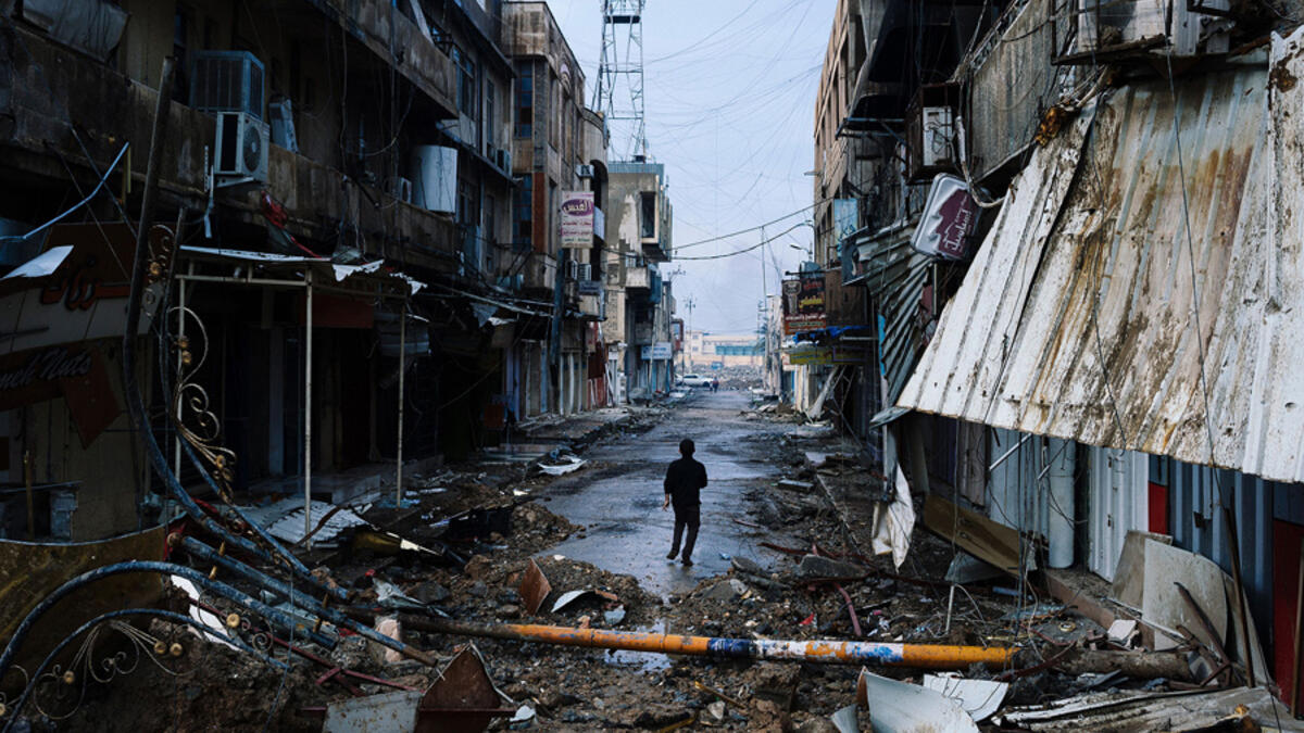 An Iraqi boy walks down a street near Mosul's University on January 22, 2017. The fight for Mosul has left six districts almost completely destroyed. Many displaced people cannot return home because their houses and livelihoods are gone. In addition, remaining mines and explosive remnants make a safe return difficult.