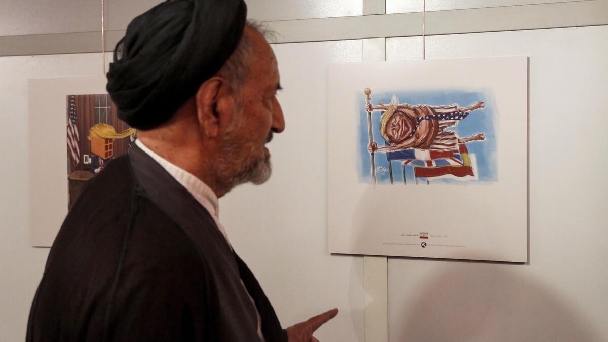 An Iranian cartoonist draws a long line of flags with the US flag in the forefront, but instead of the flag, Trump holds tight to the flagpole, in his boxers. (AFP)