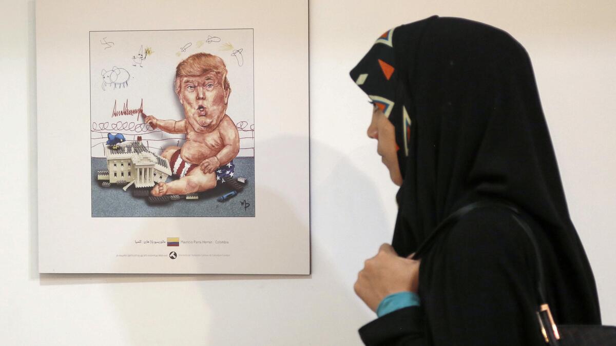 Baby Trump, playing war, drawing KKK stick men and swastikas on the wall. (AFP)