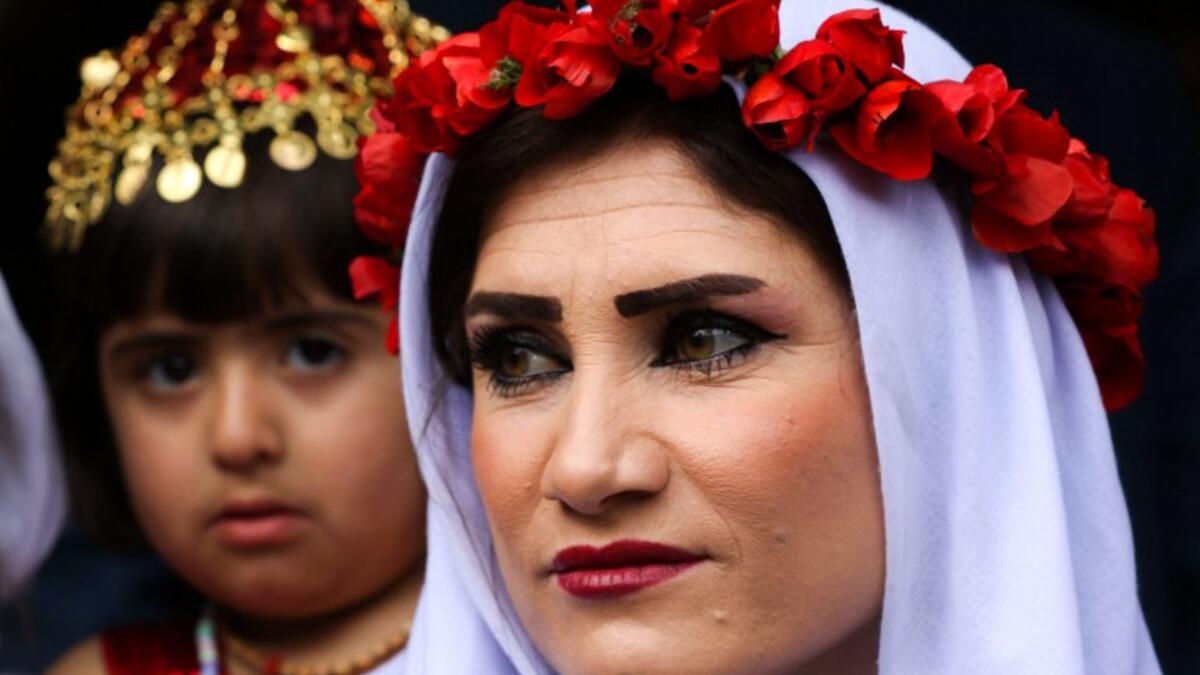 Yazidi women dress up on Charshema Sor or ‘Red Wednesday’ and visit cemeteries to offer presents to the dead whose spirits are believed to return to their graves. Presents include dishes, sweets, lamps and other things.