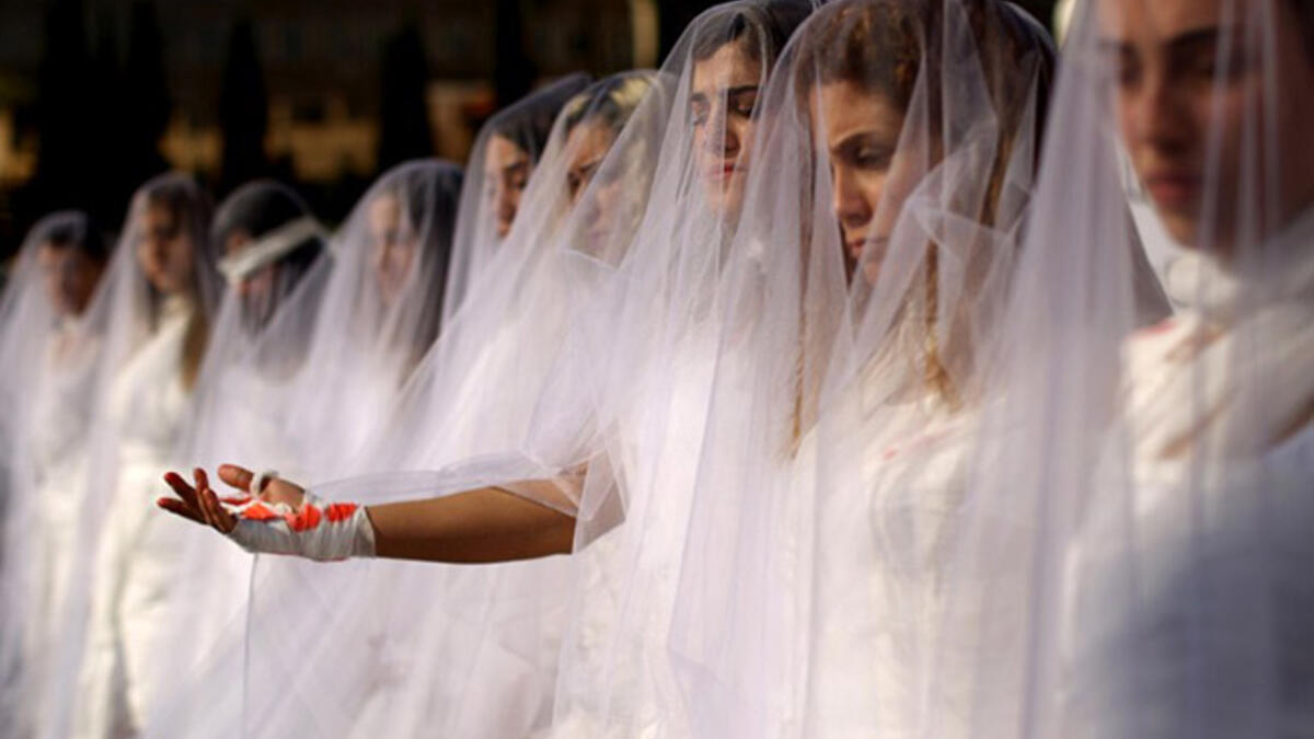 Scrapping laws that protect rapists: Activists from the Lebanese NGO Abaad (Dimensions), a resource center for gender equality, dressed as brides and wearing bandages hold a protest in downtown Beirut on December 6, 2016, against article 522 in the Lebanese penal code.