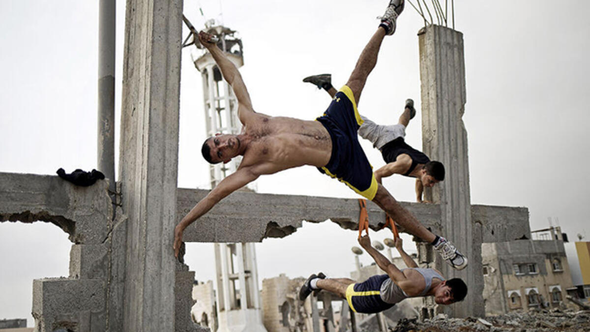 Palestinian men practice street workouts, using the rubble of war-torn Gaza as their gym.