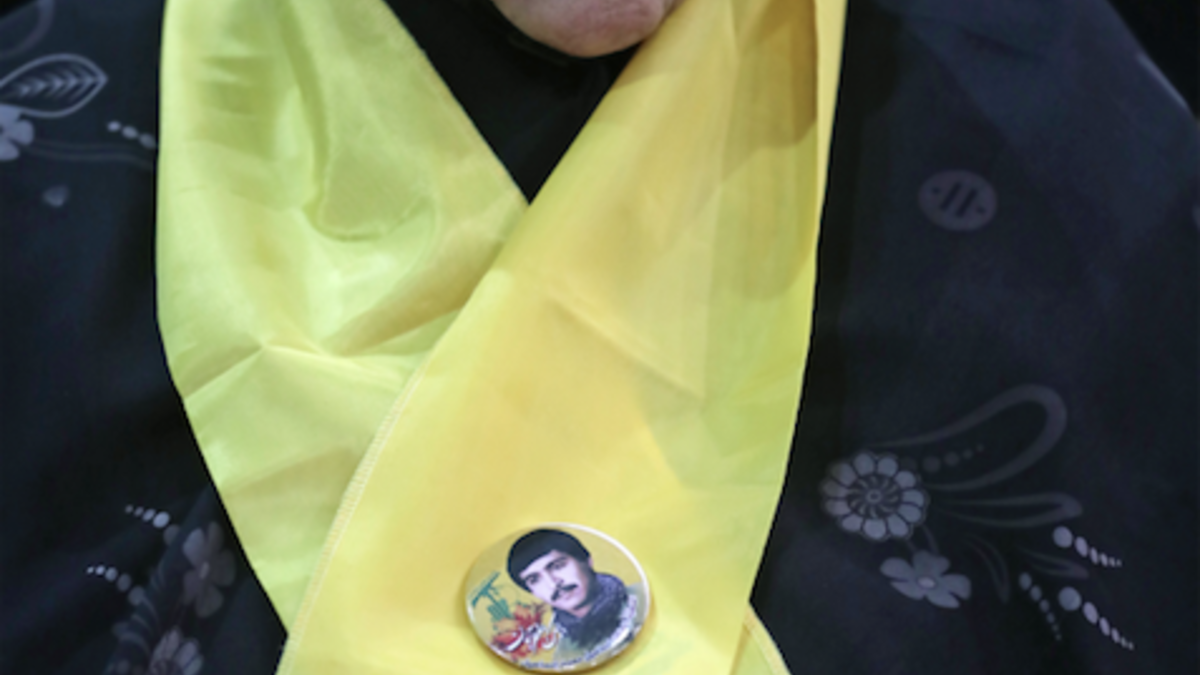 A Lebanese woman wears a scarf with the Hezbollah flag colours as she attends a gathering for a televised speech held by the Shiite party in the capital Beirut, commemorating the party's killed leaders, on February 16, 2018. 
(JOSEPH EID / AFP)