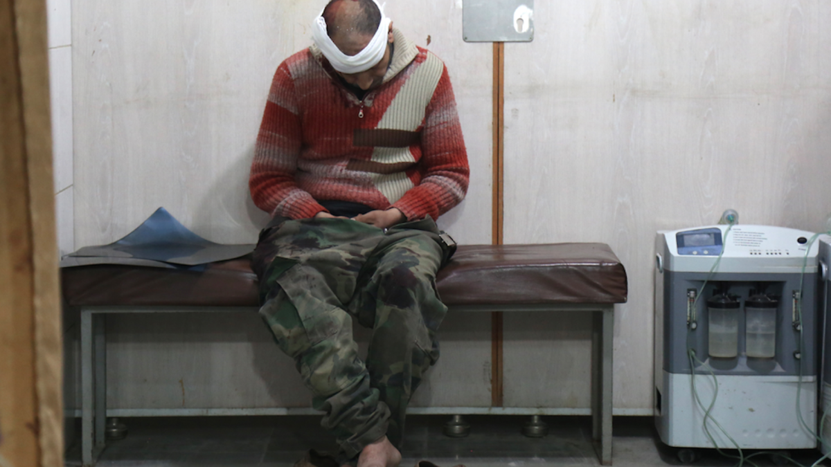 A Syrian man waits to receive treatment at a make-shift hospital in Kafr Batna following government air strikes on the town of Jisreen, in the besieged Eastern Ghouta region on Feb. 19, 2018. 
(Ammar SULEIMAN / AFP)