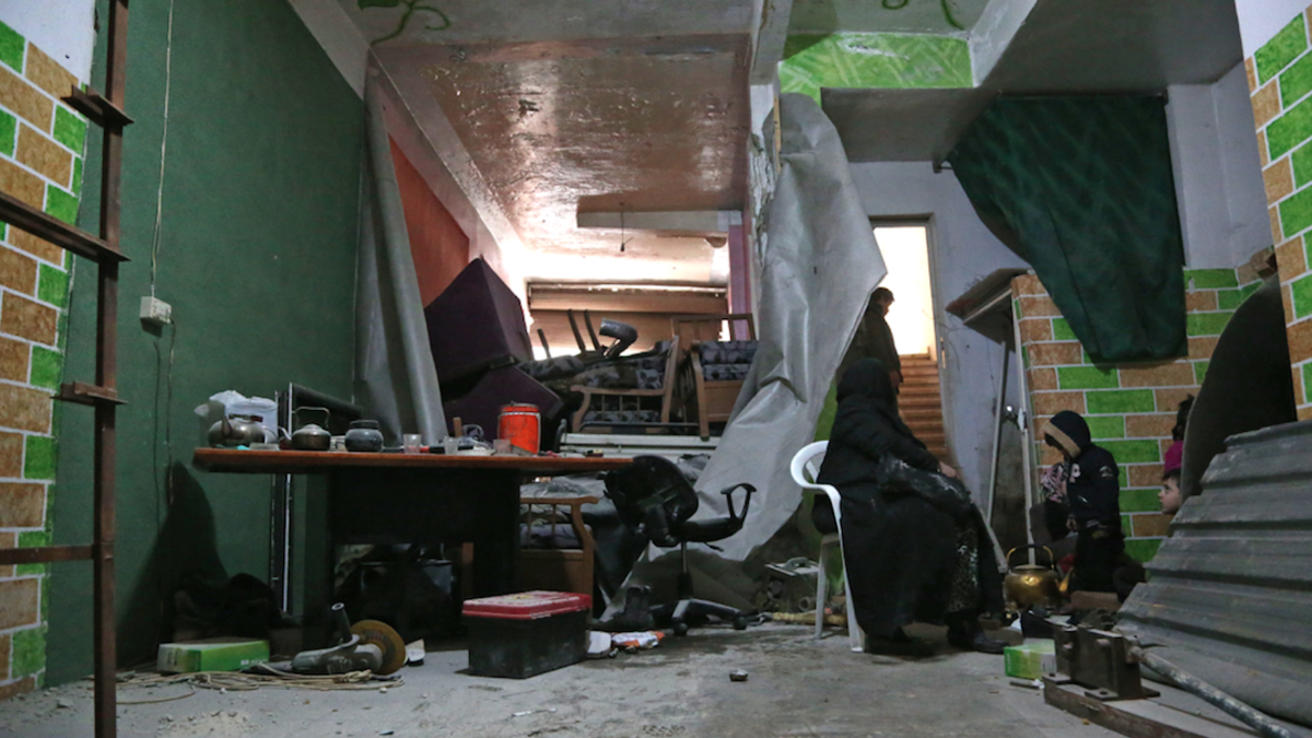 Syrian civilians take shelter during government bombing in the rebel-held town of Hamouria, in the besieged Eastern Ghouta region on the outskirts of the capital Damascus, on Feb. 19, 2018. 
(ABDULMONAM EASSA / AFP)