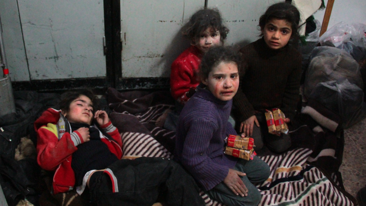 Syrian children cry at a make-shift hospital in Douma following air strikes on the Syrian village of Mesraba in the besieged Eastern Ghouta region on the outskirts of the capital Damascus, on Feb. 19, 2018. 
(Hamza Al-Ajweh / AFP)