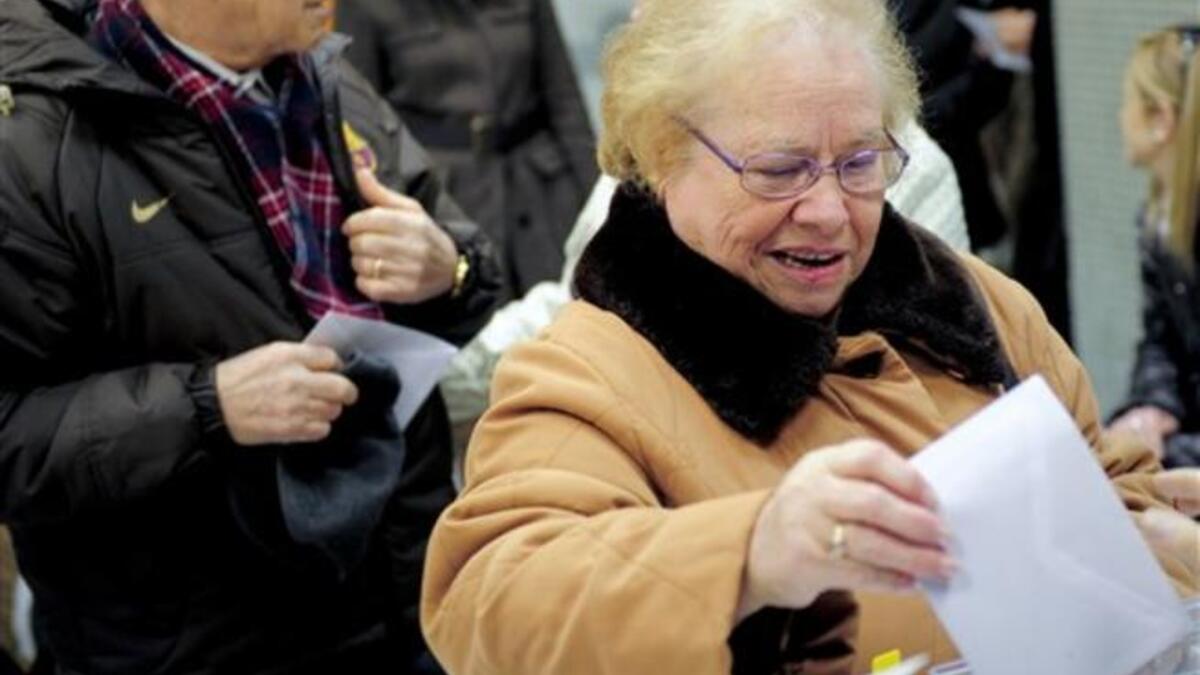 A woman casts her vote in the regional elections in Catalonia, in Barcelona. Polls indicate voters in what has traditionally been Spain's economic powerhouse will kick out the Socialist-led coalition in favour of the moderate centre-right nationalist Convergence and Union (CiU) coalition.