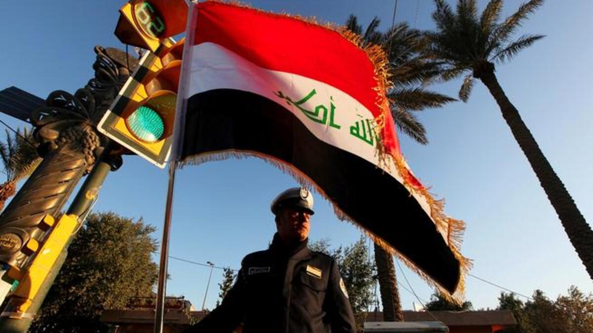 Iraqi soldier raises flag.