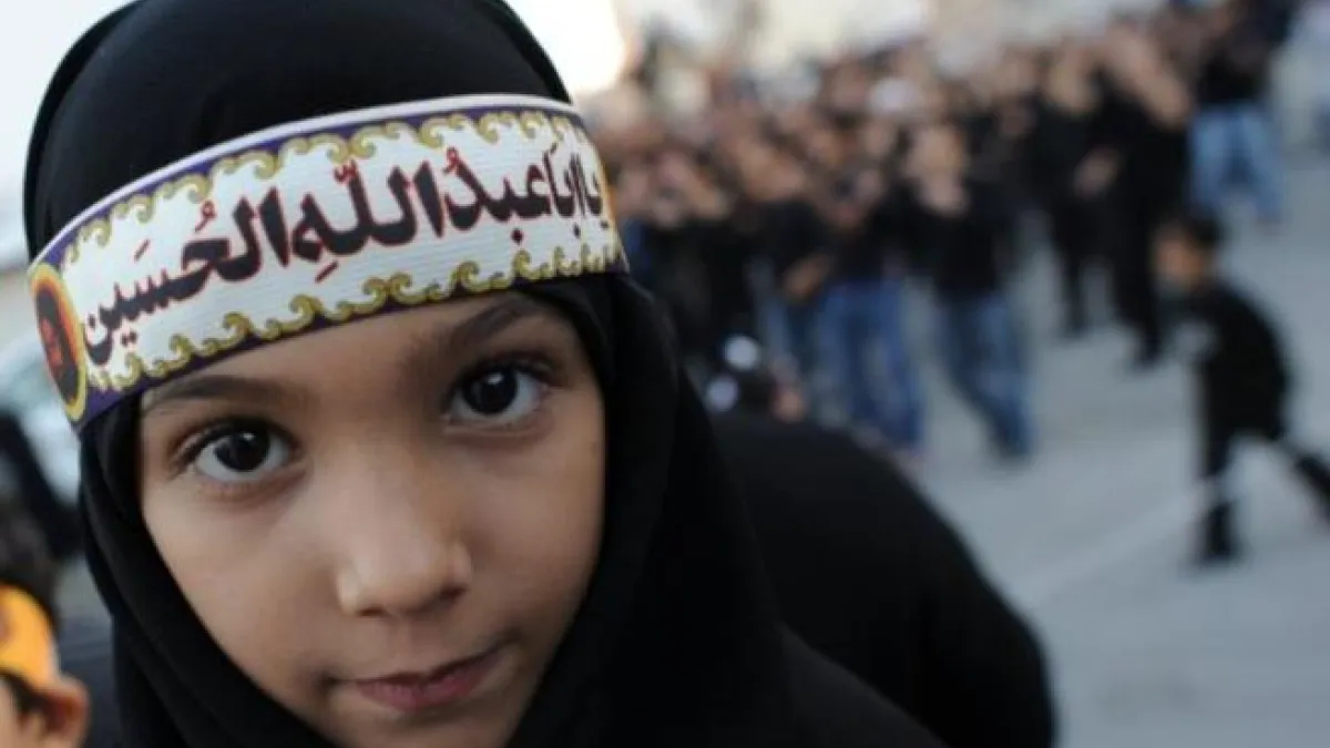 Ashura derives from 'tenth': It is a holy day for Islam marked on the 10th of 'Muharram', the first month of the Islamic lunar 
calendar. Muharram represents a period of mourning for a historical grievance in Shia Islam,
culminating Ashura. This child displays a classic lament for the revered martyr: 'O Hussein you were the father of Abdullah'.