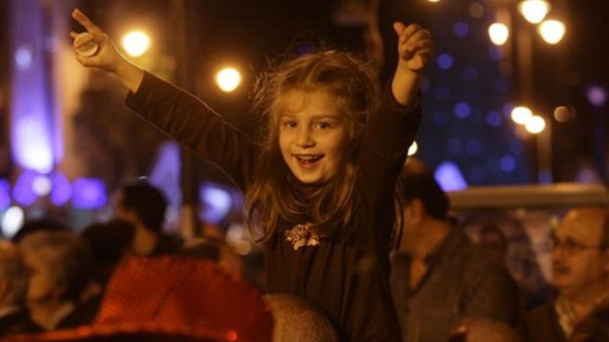 A child enjoys listening to a choir during Christmas Eve celebrations, in the Ashrafiyeh neighborhood of east Beirut.