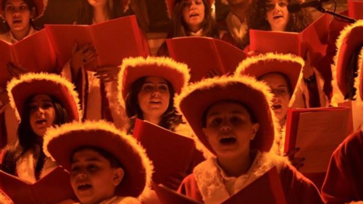 A Christian choir wearing cowboy hats sing during Christmas Eve celebrations, in the Ashrafiyeh neighborhood of east Beirut.