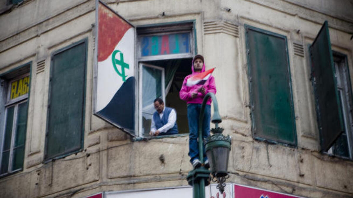 United we stand? The Unity flag of Christians & Muslim Egypt, raised jointly during the Jan 25 Revolution leading to the Mubarak ouster, belies a less harmonious story, since emerged. While Copts shared in the optimism of the revolution, with high hopes for change, they still have some way to attaining equal standing to their Muslims 'brothers'.