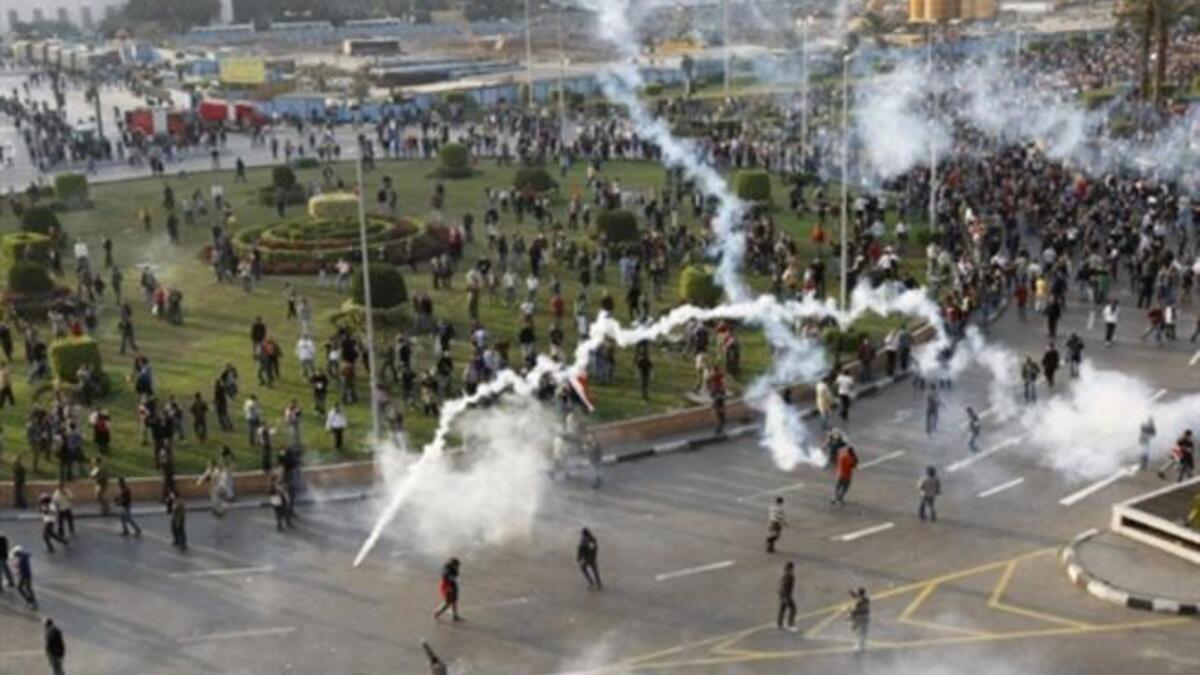 Tear gas smoke fired by Egyptian police is seen as demonstrators gather in central Cairo.