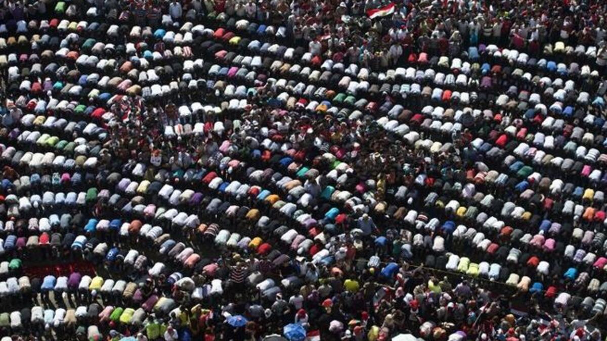 Mass mid-protest prayer session in the iconic Tahrir Square (AFP)