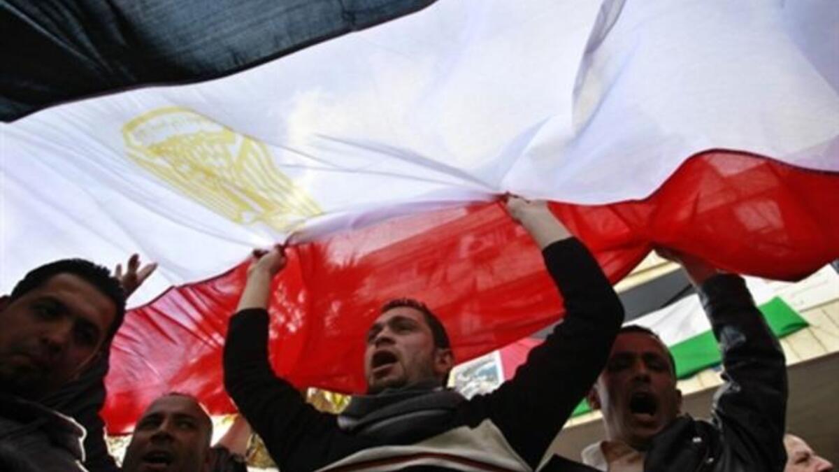 Jordanians side by side of Egyptians working in Jordan raise the Egyptian flag to salute the exit from power of a former unpopular leader.