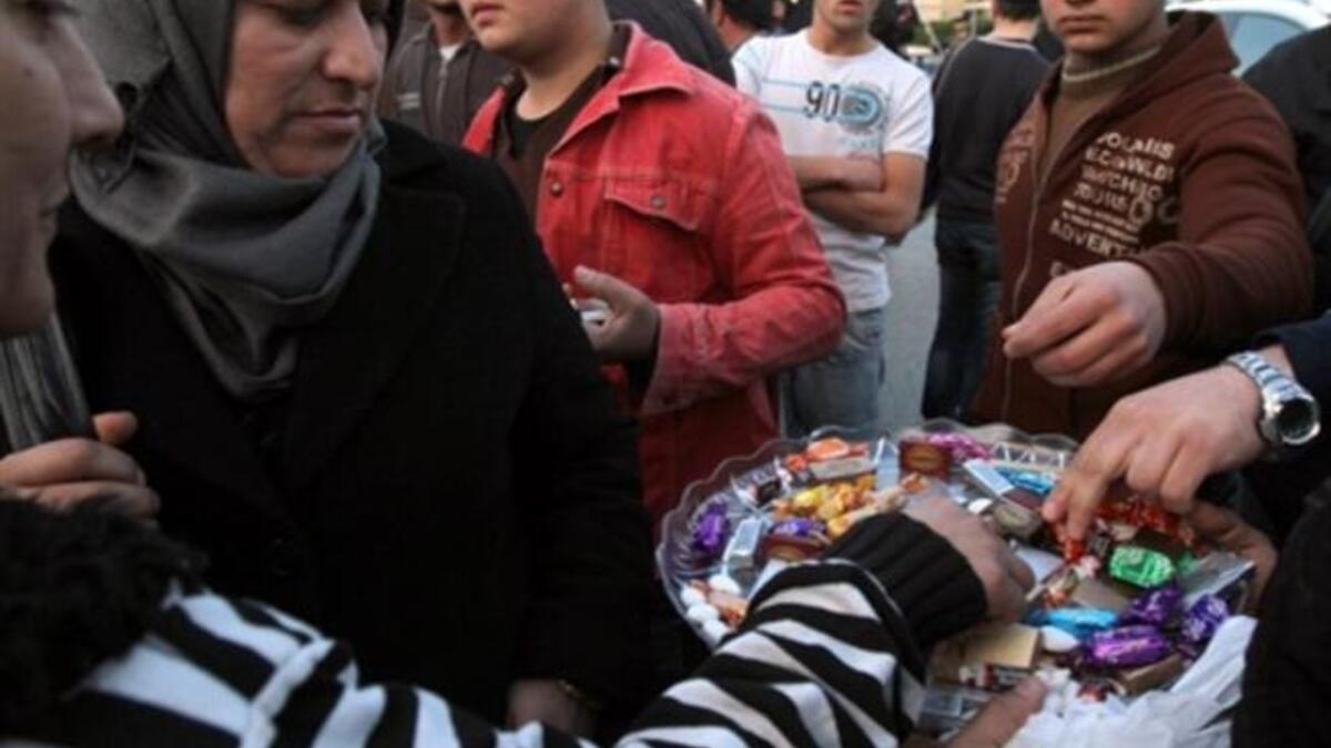 In Lebanon, sweets are distributed outside the embassy in Beirut to celebrate the sweet victory marked by the resignation of Egypt's Hosni Mubarak, President of the Republic of Egypt, Friday, February 11, 2011.