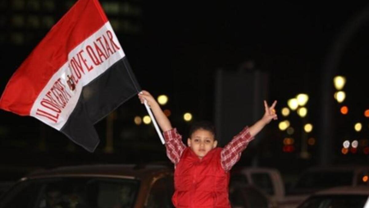 Egyptian boy bears the note of endearment: "love Egypt, love Qatar"  during celebrations by his community of Mubarak's downfall.