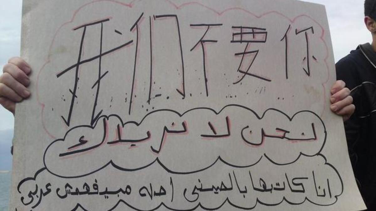 "We don't want you. I wrote it in Chinese because he doesn't understand Arabic".