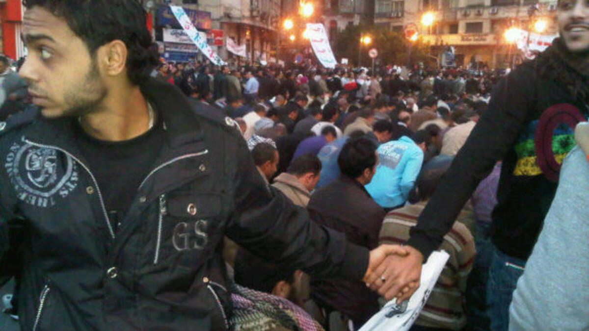 All Egyptians rally round each other: Coptic Christian Egyptians protecting the Muslim Egyptians during prayer.