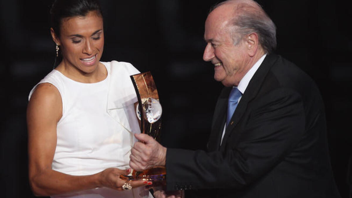 Marta (L) of Brazil winner of the women's player of the year receives her award from FIFA President Sepp Blatter (R).