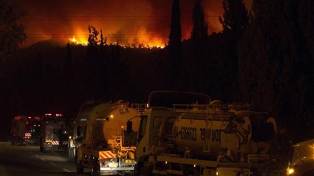 Israeli water tankers arrive to extinguish  a raging fire  in the city of Kiyriat Carmel, Carmel Forest