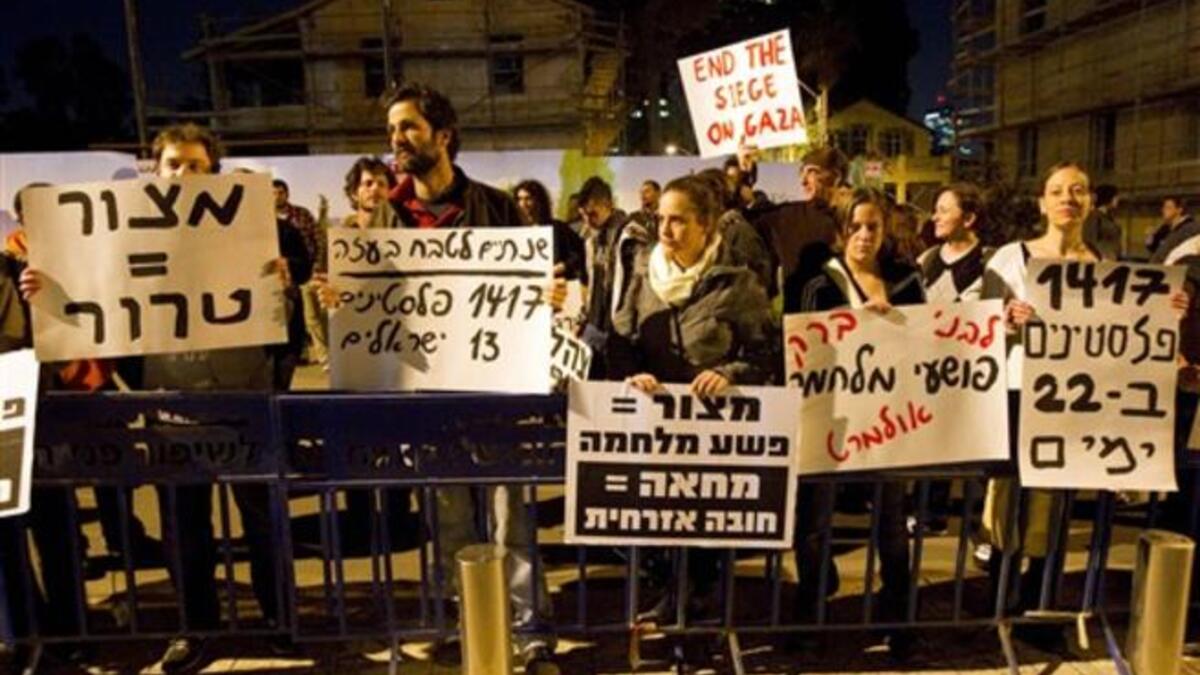 Around a hundred pacifist and leftist Israelis, holding up placards against the blockade imposed by Israel on Gaza since 2007, demonstrate outside the Jewish state's ministry of defense in Tel Aviv.