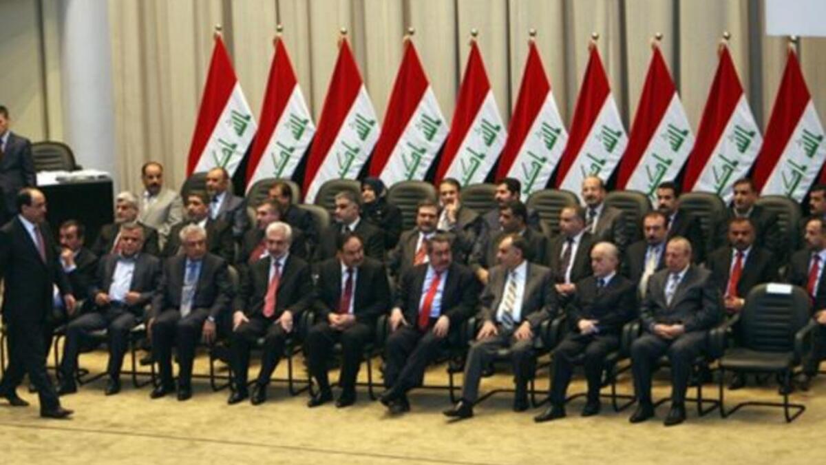 Iraqi Prime Minister walks towards his seat past members of his new cabinet during a parliamentary session in Baghdad in which lawmakers unanimously approved the new government to be headed by the incumbent Shiite premier.