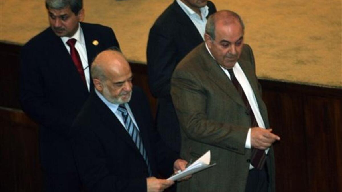 Iraqi former prime minister and now member of Parliament and head of the Iraqiya bloc Iyad Allawi (R) and former Iraqi prime minister Ibrahim al-Jaafari, now member of Parliament and of the National alliance, walk together in parliament.