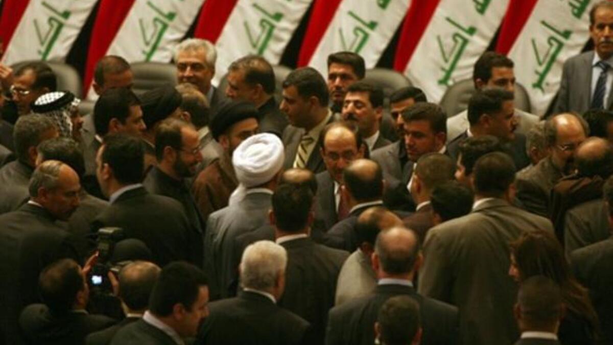 Iraqi Prime Minister Nuri al-Maliki is surrounded by lawmakers in the parliament after giving him a vote of confidence and adopted a 43-point program.