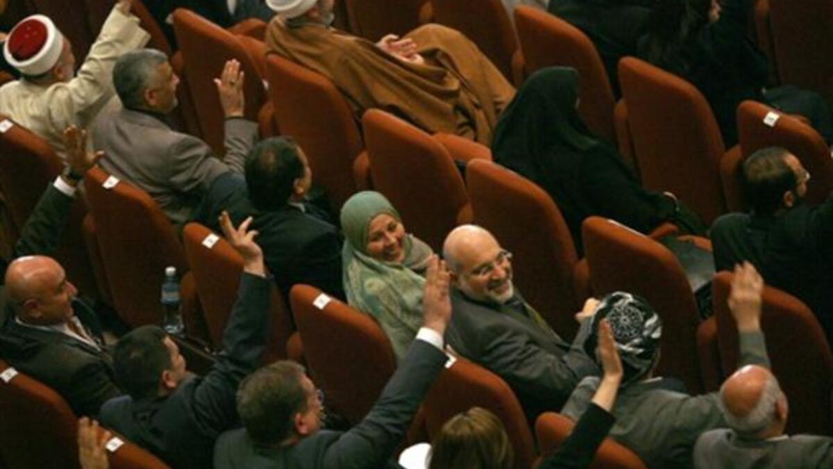 Iraqi MPs vote in parliament in Baghdad as lawmakers gave Prime Minister Nuri al-Maliki's government a vote of confidence and adopted a 43-point program aimed at liberalising the economy and fighting terrorism.