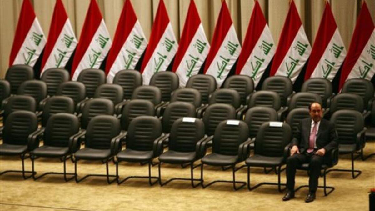 Iraqi Prime Minister Nuri al-Maliki waits for the members of his new cabinet to arrive during a parliamentary session in Baghdad in which lawmakers unanimously approved the new government which will be headed by the incumbent Shiite premier.