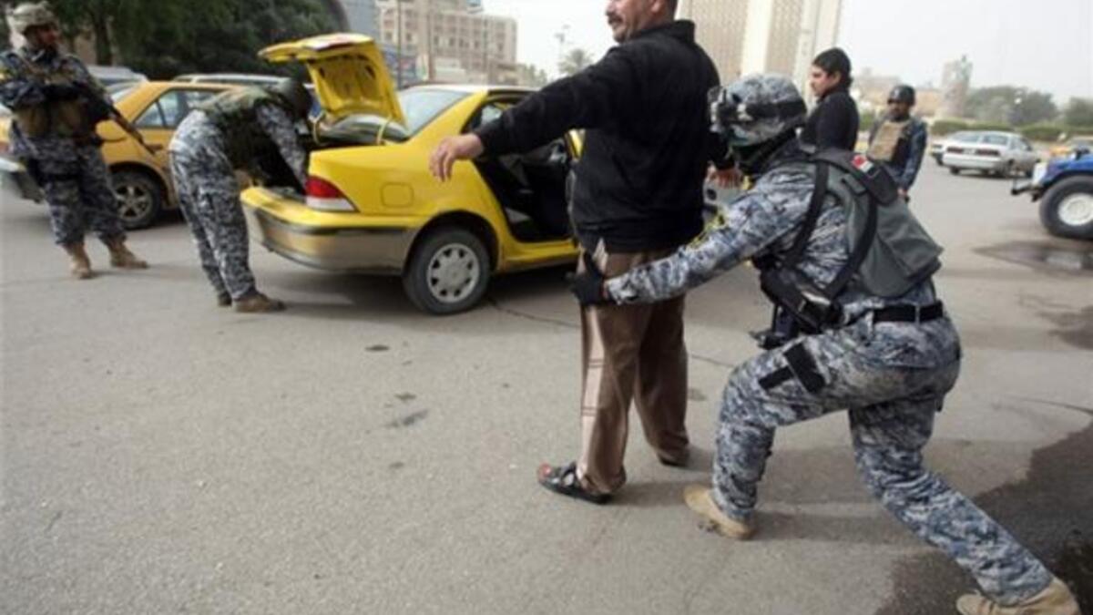 Iraqi troops implement strict security measures on main roads in Baghdad,as Shiite Muslims prepare to mark the religious event of Ashura on December 17 at the end of ten days of mourning for in commemoration of the 7th century killing of Imam Hussein.