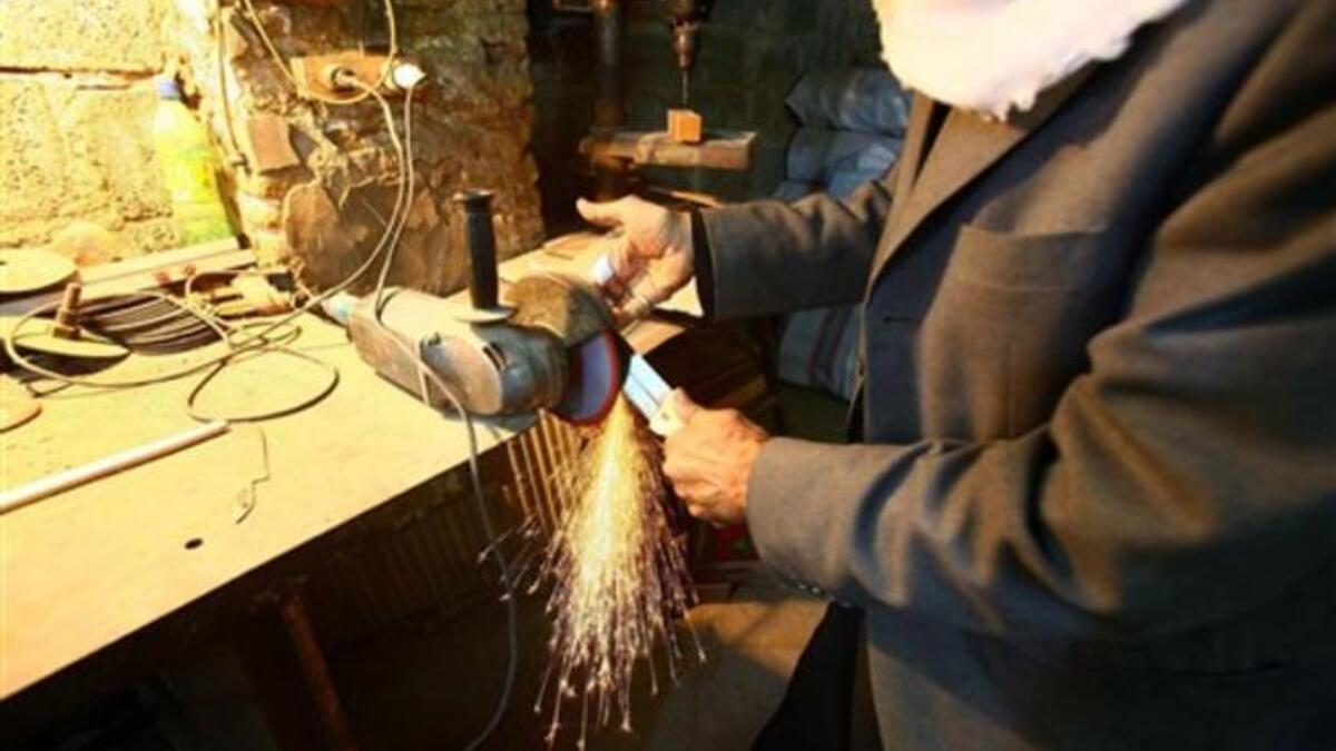 An Iraqi vendor sharpens knives used for the ritual of self flagellation by Shiite Muslims during the 10 mourning period of Ashura in the shrine city of Karbala.