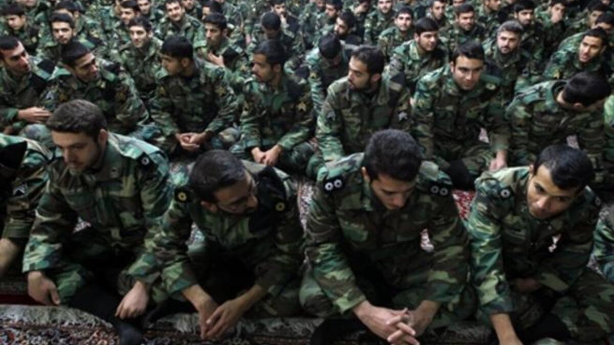 Iranian soldiers sit during the ceremony.