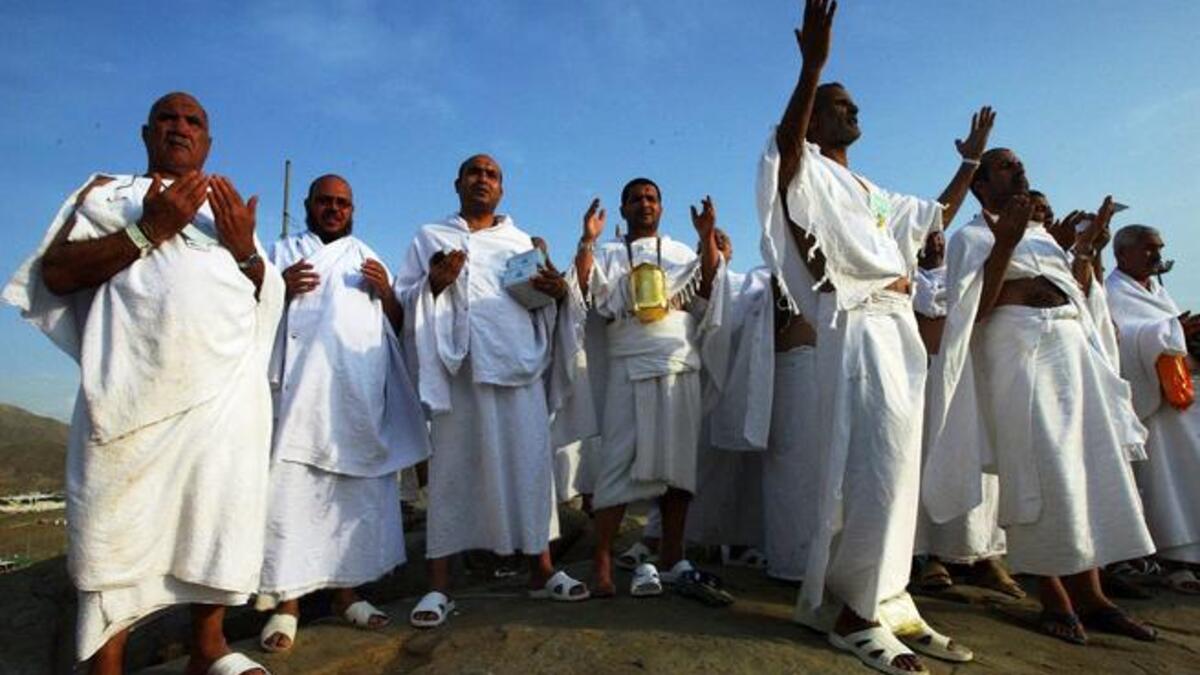 The Hajjis or pilgrims wear simple white clothes called Ihram: Male Muslims put on 2 clean, unstitched, white,
pieces of cloth. One sheet is wrapped around the lower part of the body and the other sheet around the upper body; the 
head should not be covered. Women may perform pilgrimage in the cloths they are wearing, without the face veil.