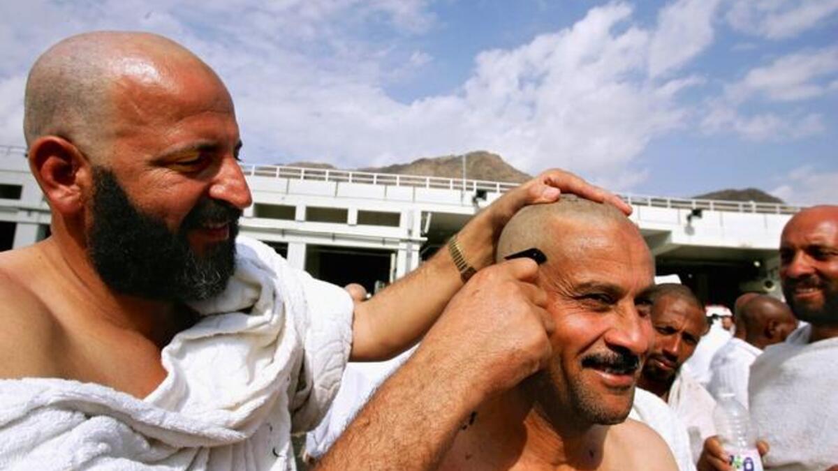 After offering the sacrifices, a male pilgrim should have his head shaven and female pilgrims are required to cut a small part
of her hair, say a lock of their hair. Female pilgrims are not permitted to have their heads shaven. After the hair cut, 
one can remove the Ihram and may now wear regular clothes.