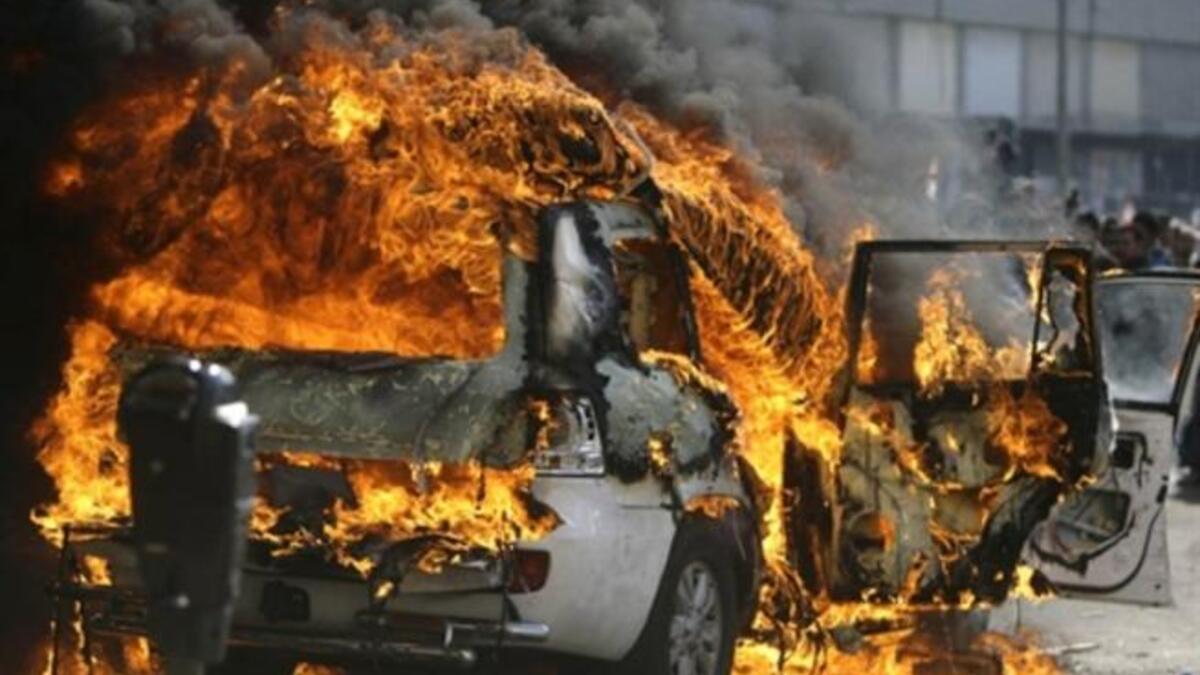 Supporters of the Future Movement torch the vehicle belonging to the Arabic language al-Jazeera satellite television station during a demonstration in support of the caretaker prime minister Saad Hariri in the Sunni bastion coastal city of Tripoli.