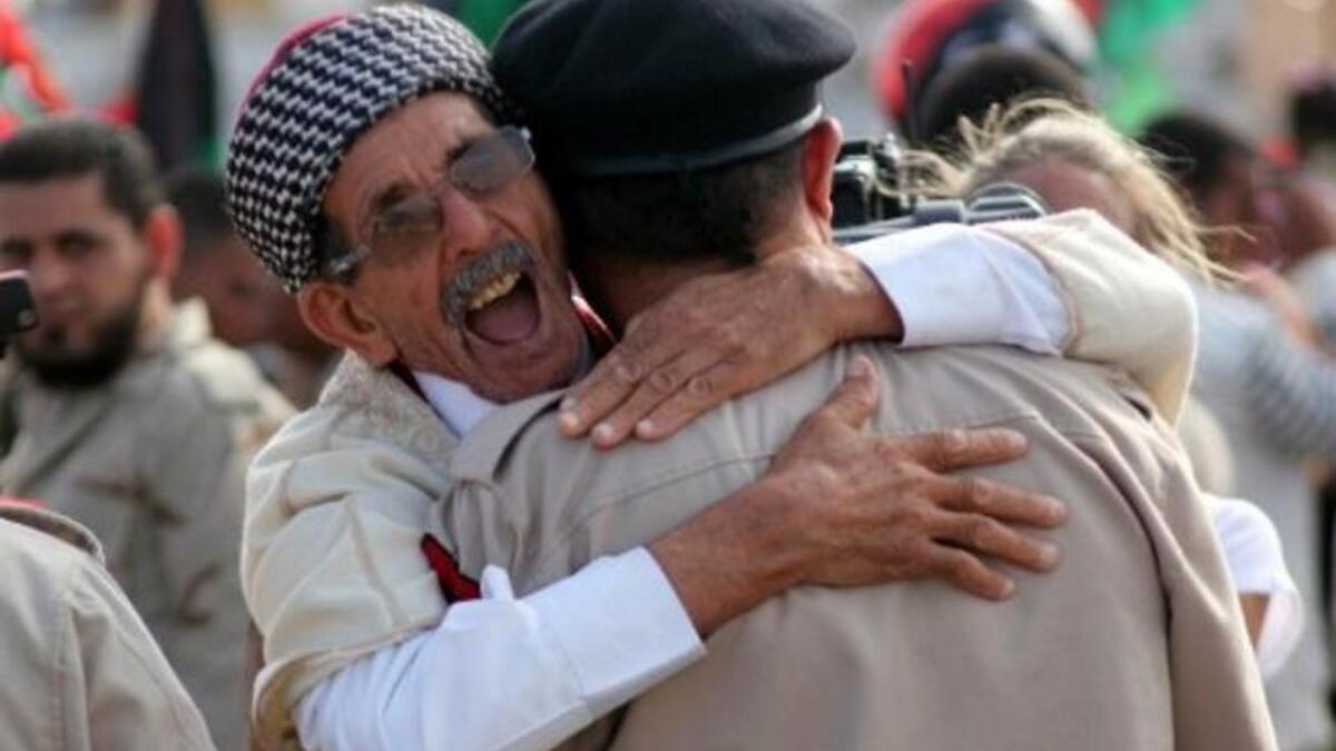 Libyans celebrate following the official day of liberation for the country in the eastern city of Benghazi on October 23, 2011
 just days after ousted Colonel Kadhafi was captured and killed.